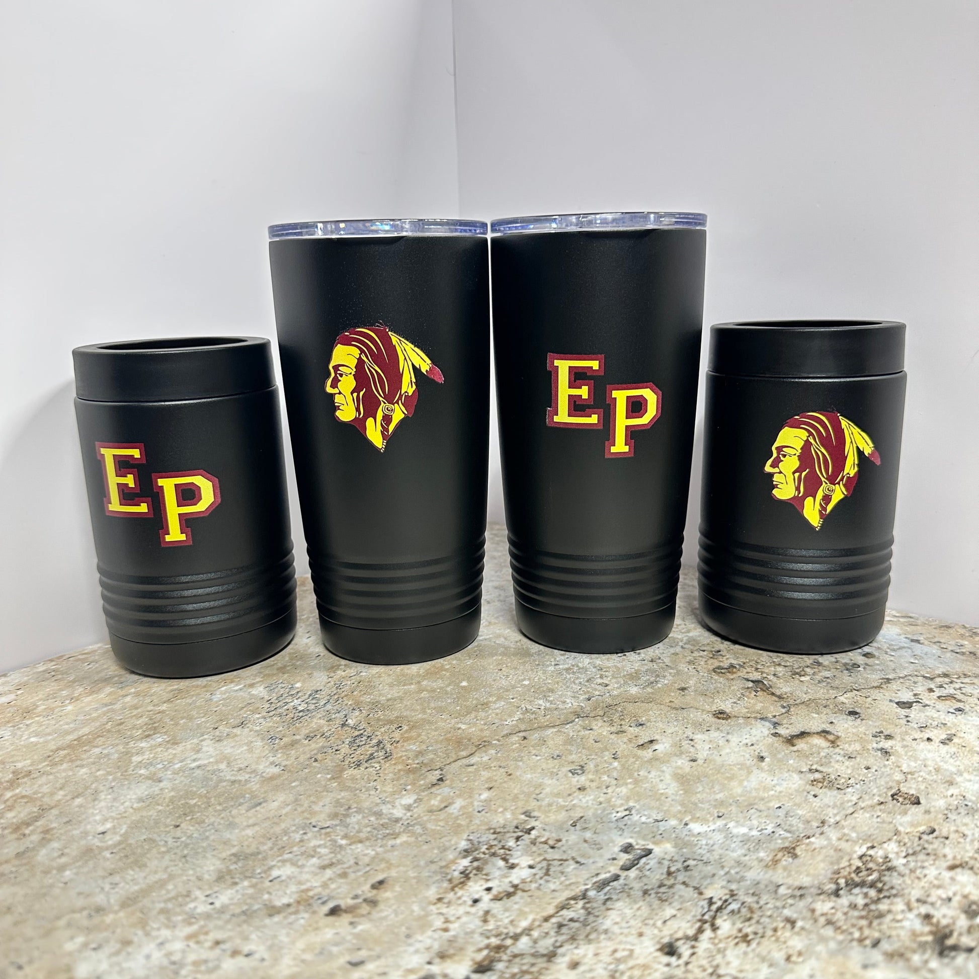 Set of black tumblers with 'Ep' logo on a stone surface