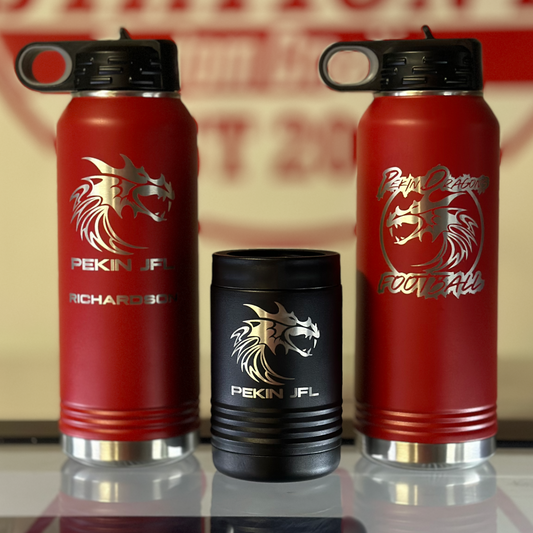 Red water bottles with a logo on a reflective surface in front of a 'Station 2' sign.