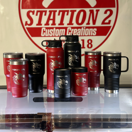 Collection of red and black tumblers with a visible brand logo in the background.