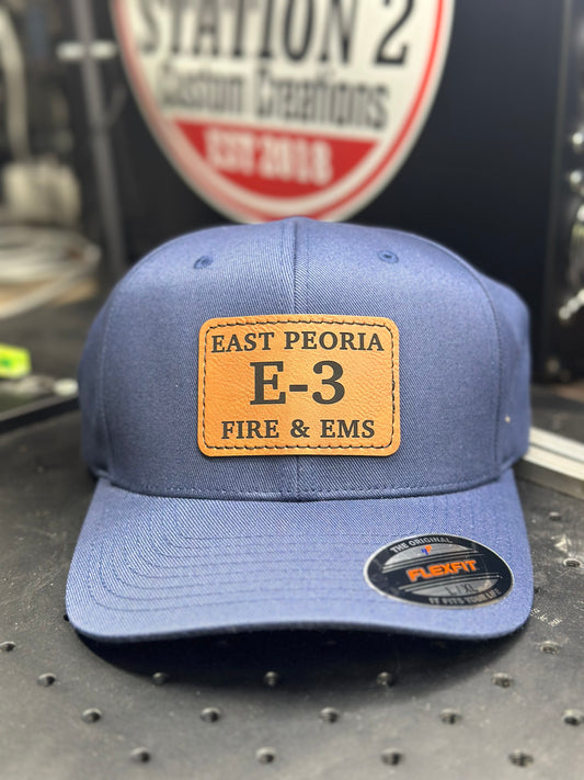 Blue Flexfit 6277 hat with engraved East Peoria Fire E-3 leatherette patch