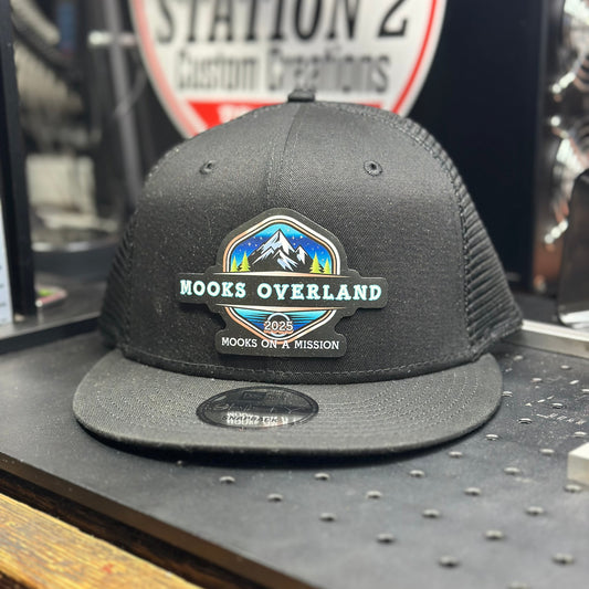 Charcoal New Era 9FIFTY trucker snapback with a full-color Mooks Overland patch