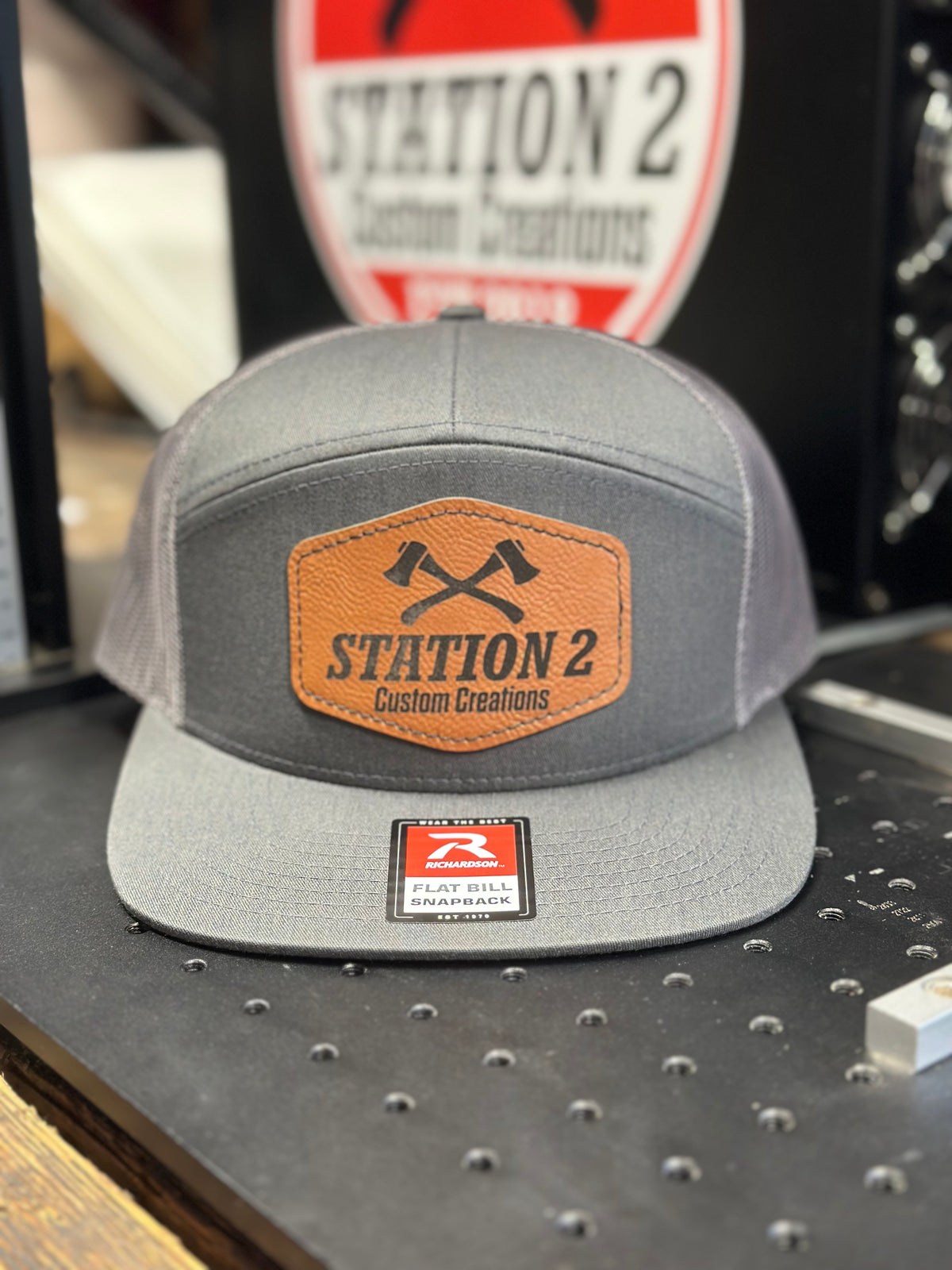 Heather grey Richardson 168 seven-panel hat with engraved rawhide crossed-axes patch