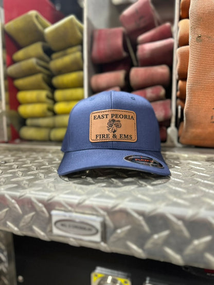Navy East Peoria Fire and EMS engraved patch hat shown at the fire station