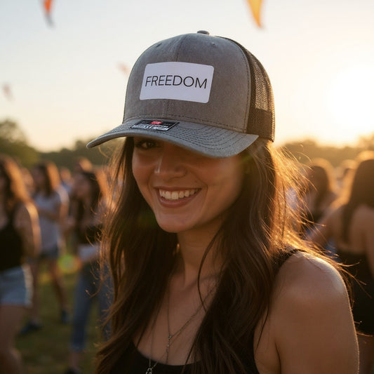 Woman wearing the FREEDOM leatherette patch hat at an outdoor summer event