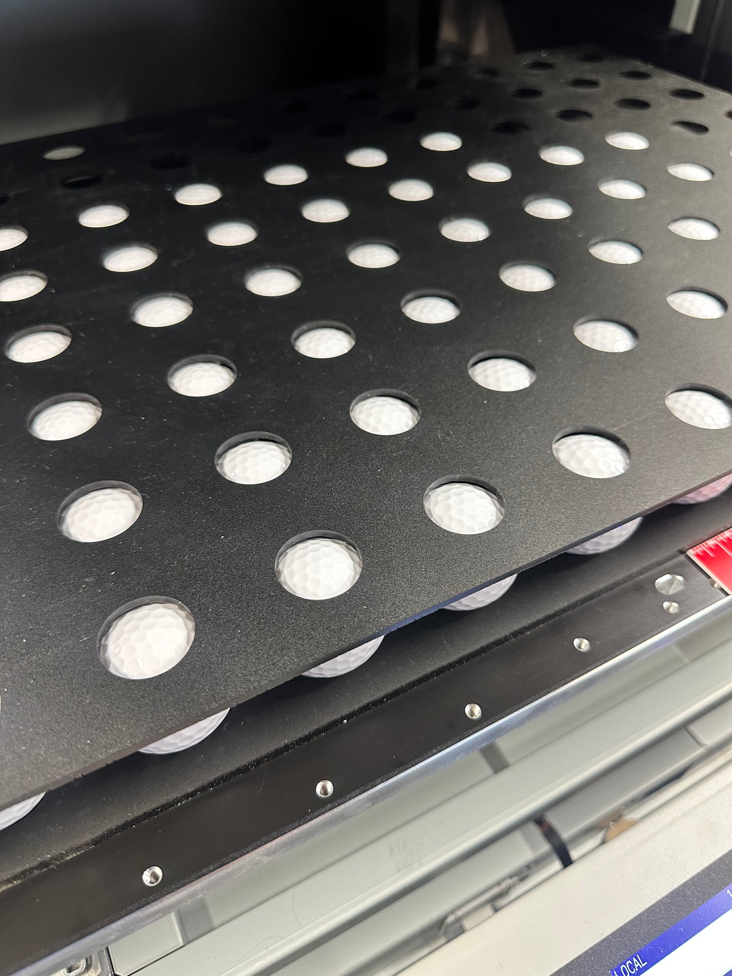 Golf ball jig for the Mimaki UJF-6042, empty, close-up of the holder pockets