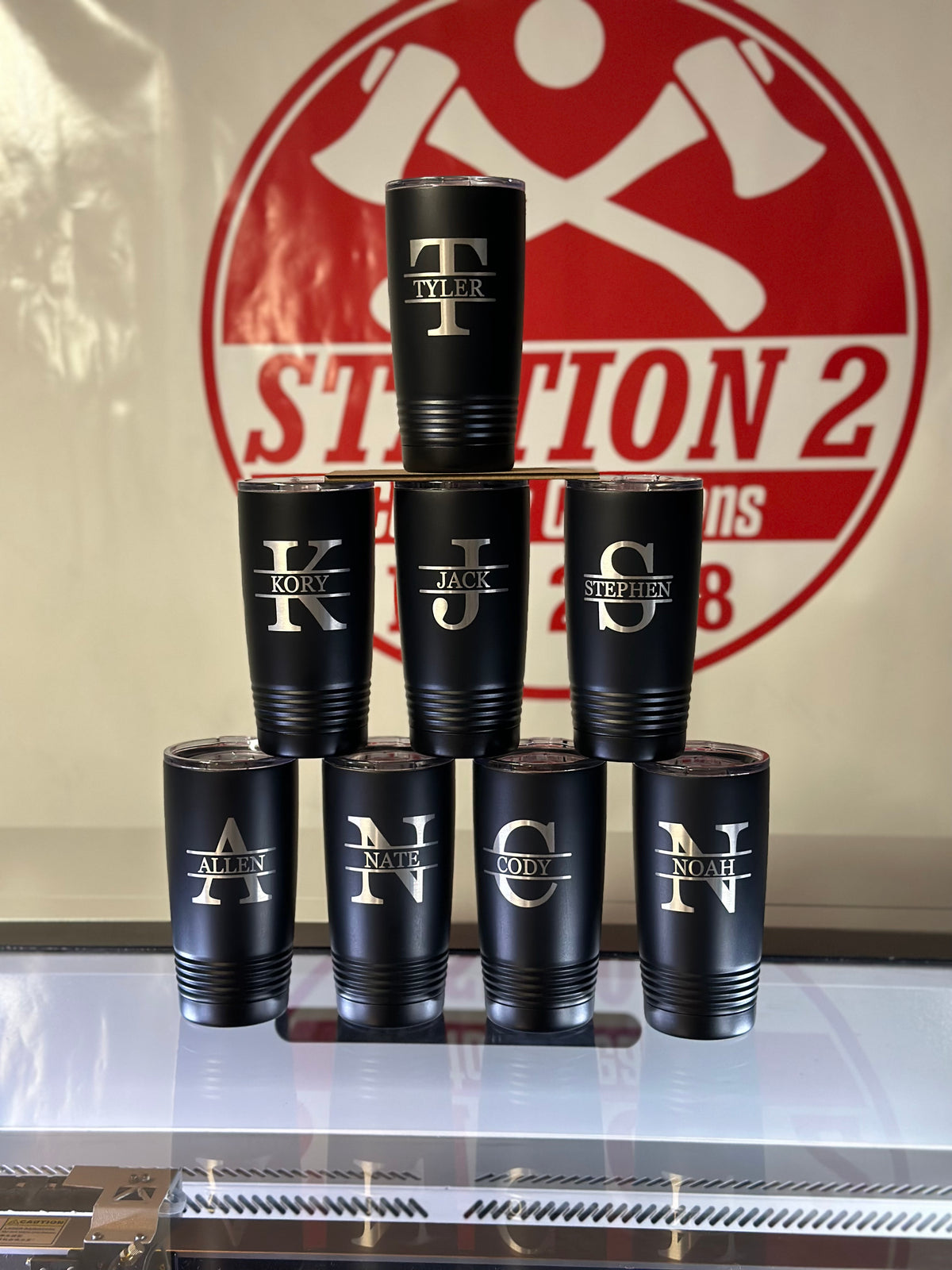 Black tumblers and can coolers engraved with individual monogram initials